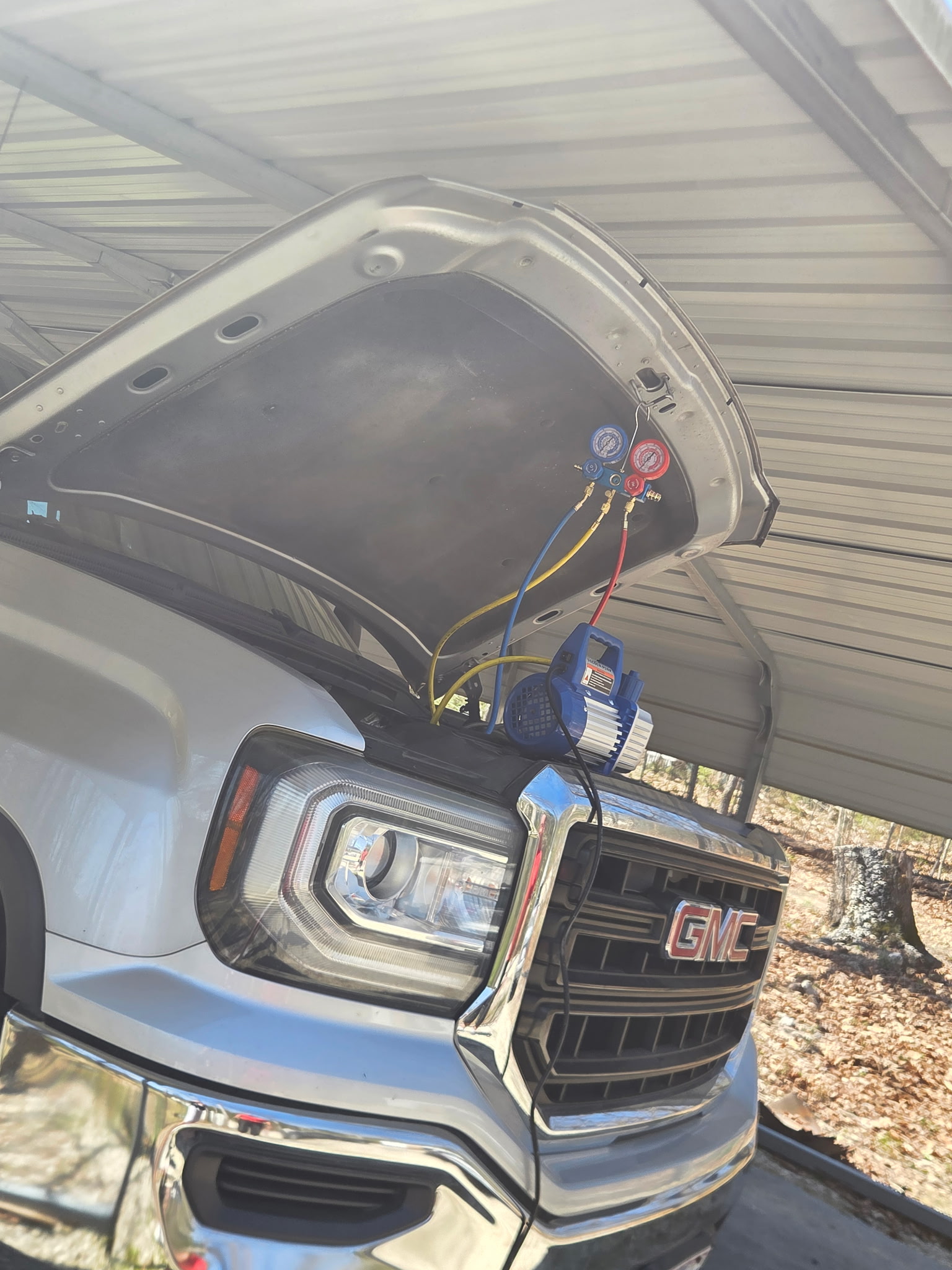 GMC truck with AC gauges on hood during mobile service
