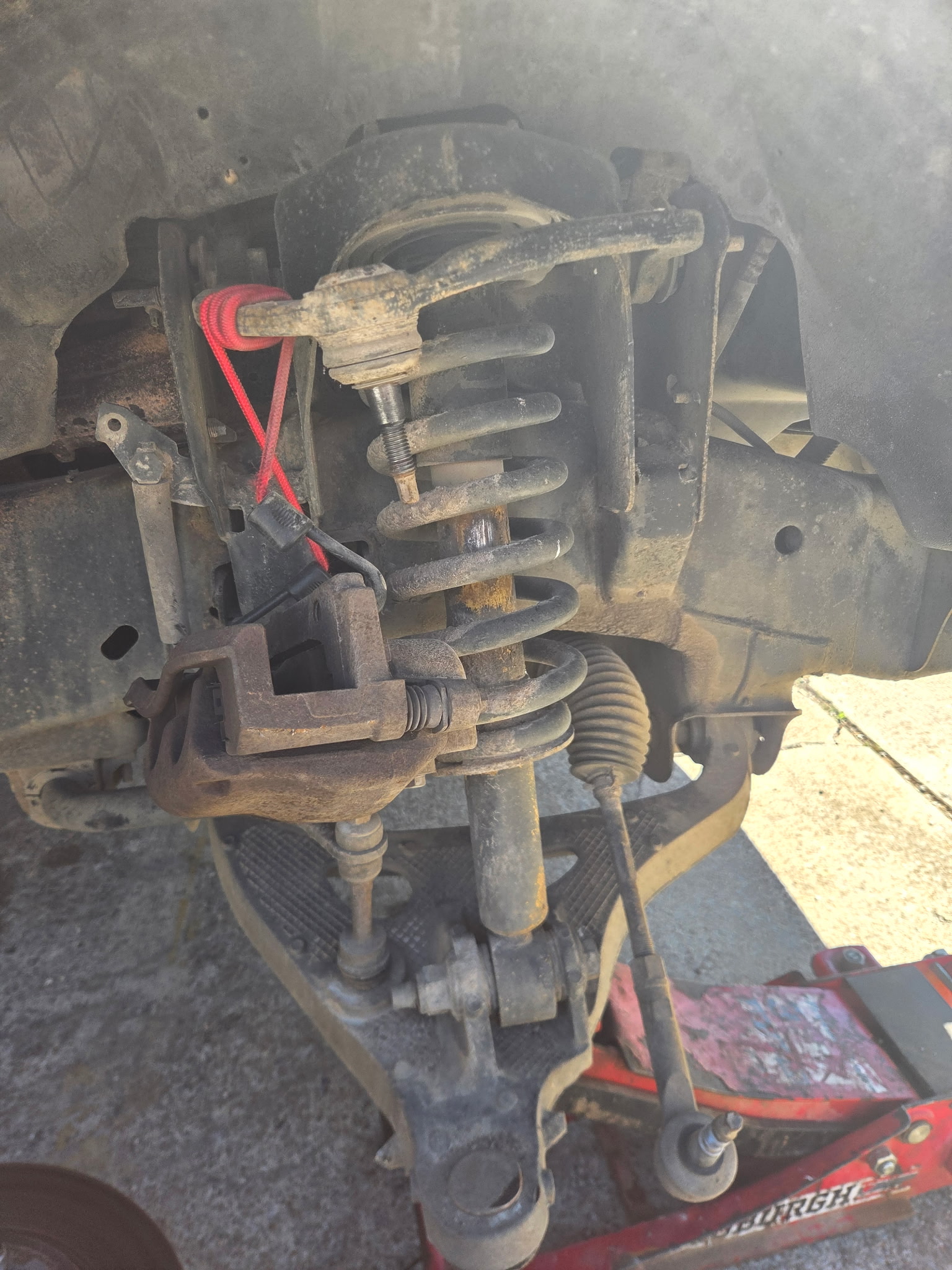 Suspension spring assembly being serviced